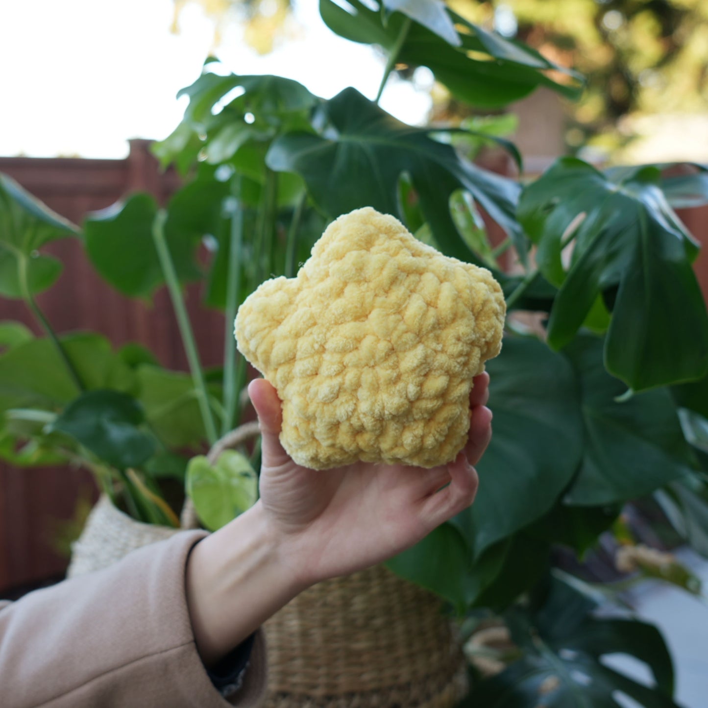 cute soft yellow crochet star with happy face, stuffed animal plushie toy handmade with yarn